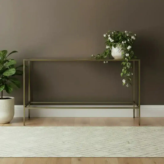 Modern console table against a brown wall with a plant on the left.