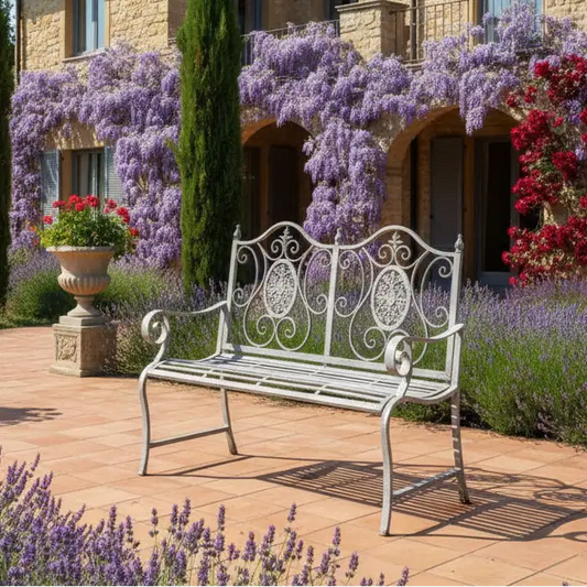 Decorative garden bench in front of a house with flowering plants