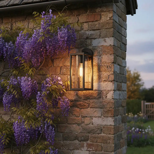 Stone building with wisteria and outdoor light fixture