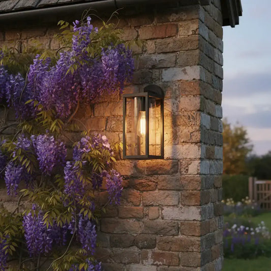 Stone building with wisteria and outdoor light fixture