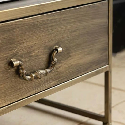 Wooden drawer with metal handle on a blurred background