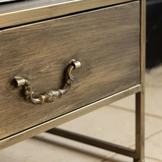Wooden drawer with metal handle on a blurred background