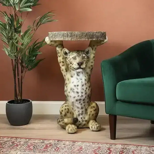 Decorative room with a green armchair, leopard statue, and potted plant on a brown wall background.