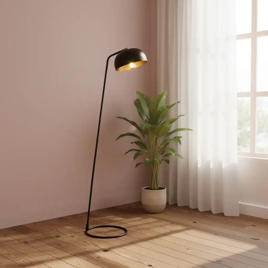 Modern floor lamp with a plant on a wooden floor in a room with pink walls and a window.