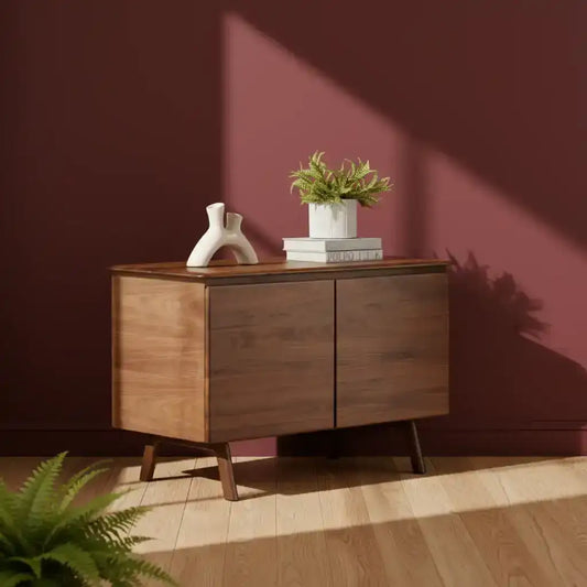 Wooden cabinet with decorative items against a maroon wall