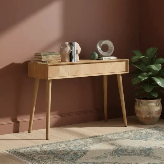 Wooden console table with decorative items on a white background