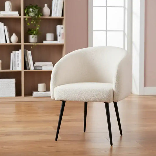Beige armchair in a room with wooden floor and bookshelf