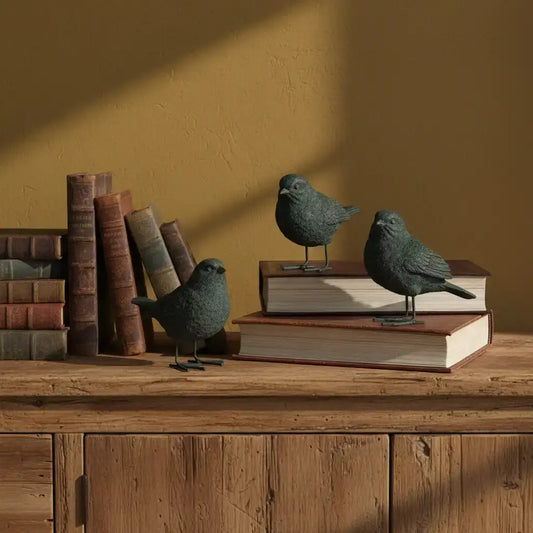 Decorative birds on books against a warm brown wall
