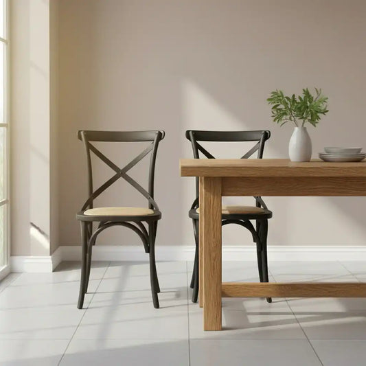 Dining table with two chairs in a room with a neutral wall and tiled floor.