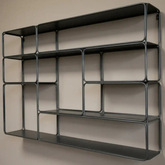 Black metal wall shelf against a brick wall background