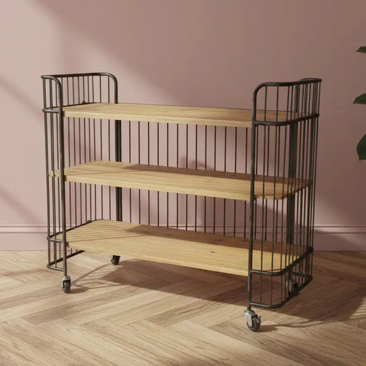 Three-tiered wooden shelf with metal frame against a pink wall