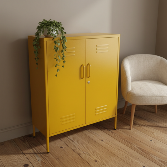 Yellow cabinet with gold handles next to a beige chair on a wooden floor.