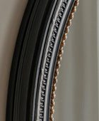 Close-up of a decorative mirror frame with intricate detailing.