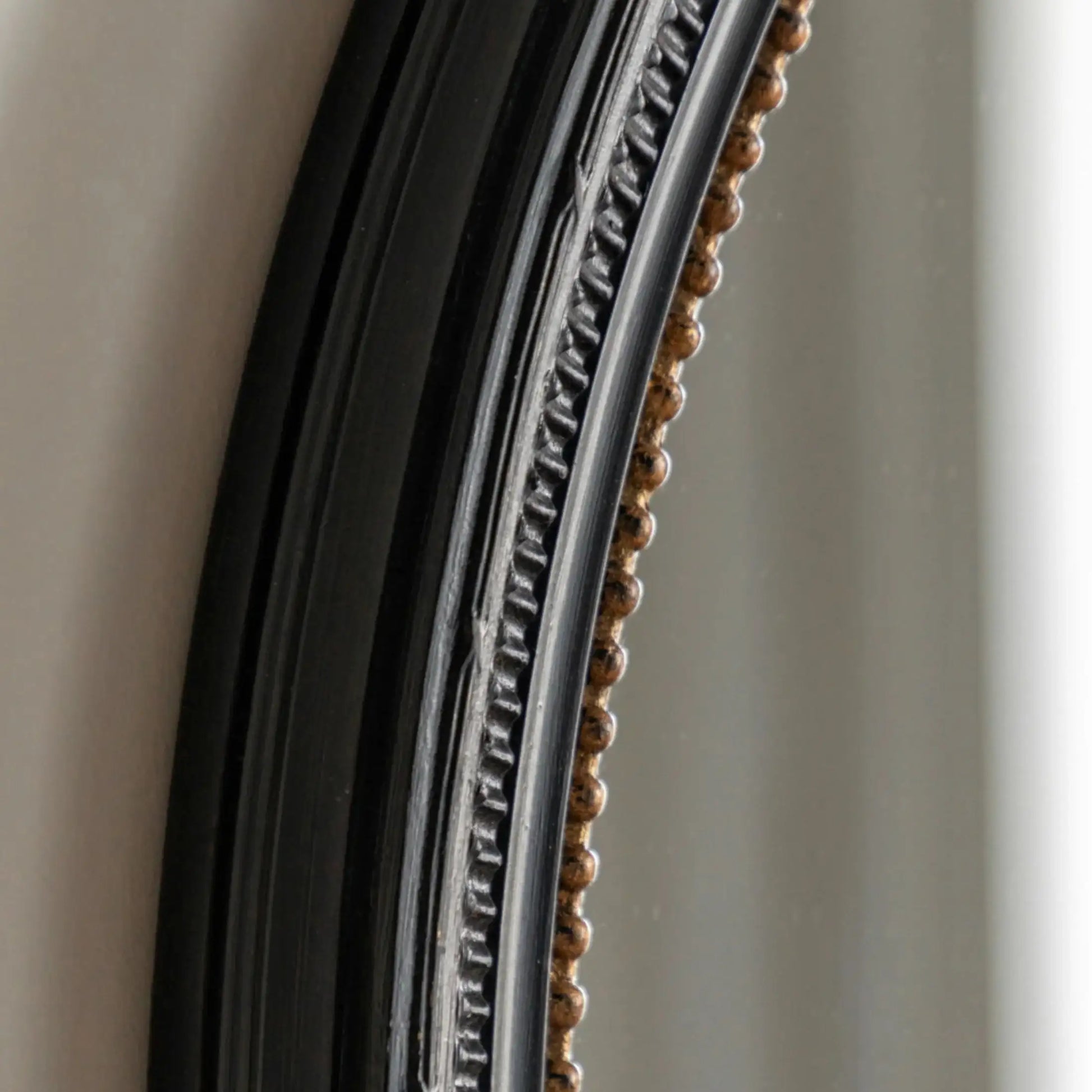 Close-up of a decorative mirror frame with intricate detailing.