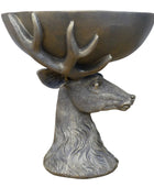Bronze deer head with bowl on a wooden surface