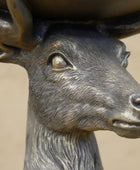 Bronze statue of a deer head with blurred background