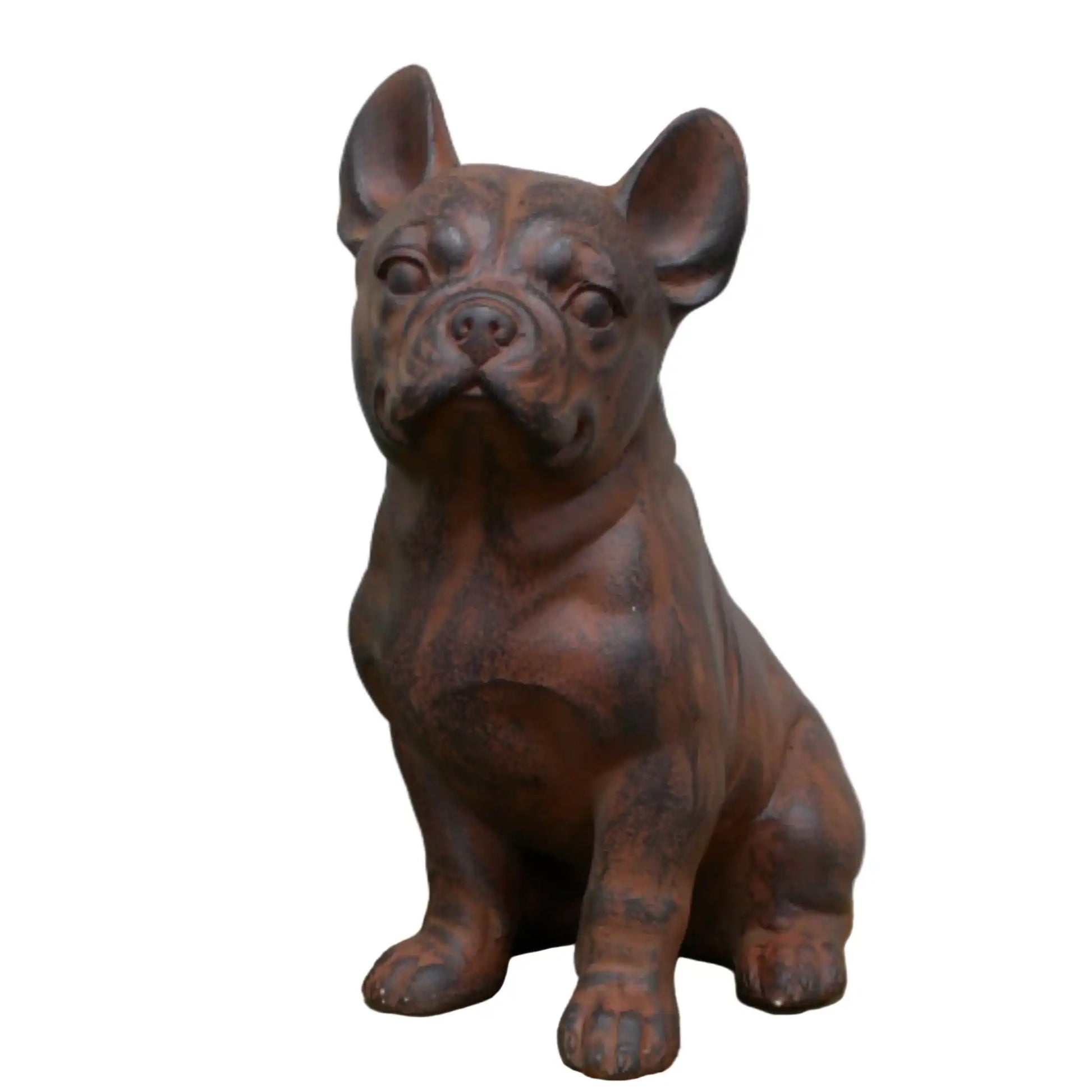 Brown dog statue on a wooden surface with a plant in the background