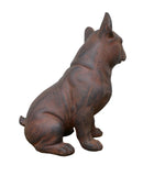 Cast iron dog statue on a wooden surface with a white background