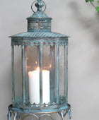Decorative lantern with a candle inside on a neutral background