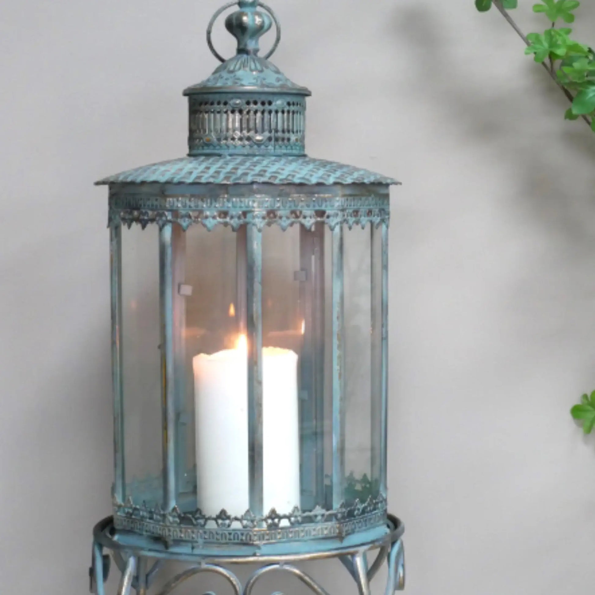 Decorative lantern with a candle inside on a neutral background
