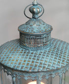 Decorative blue lantern with intricate design on a white background
