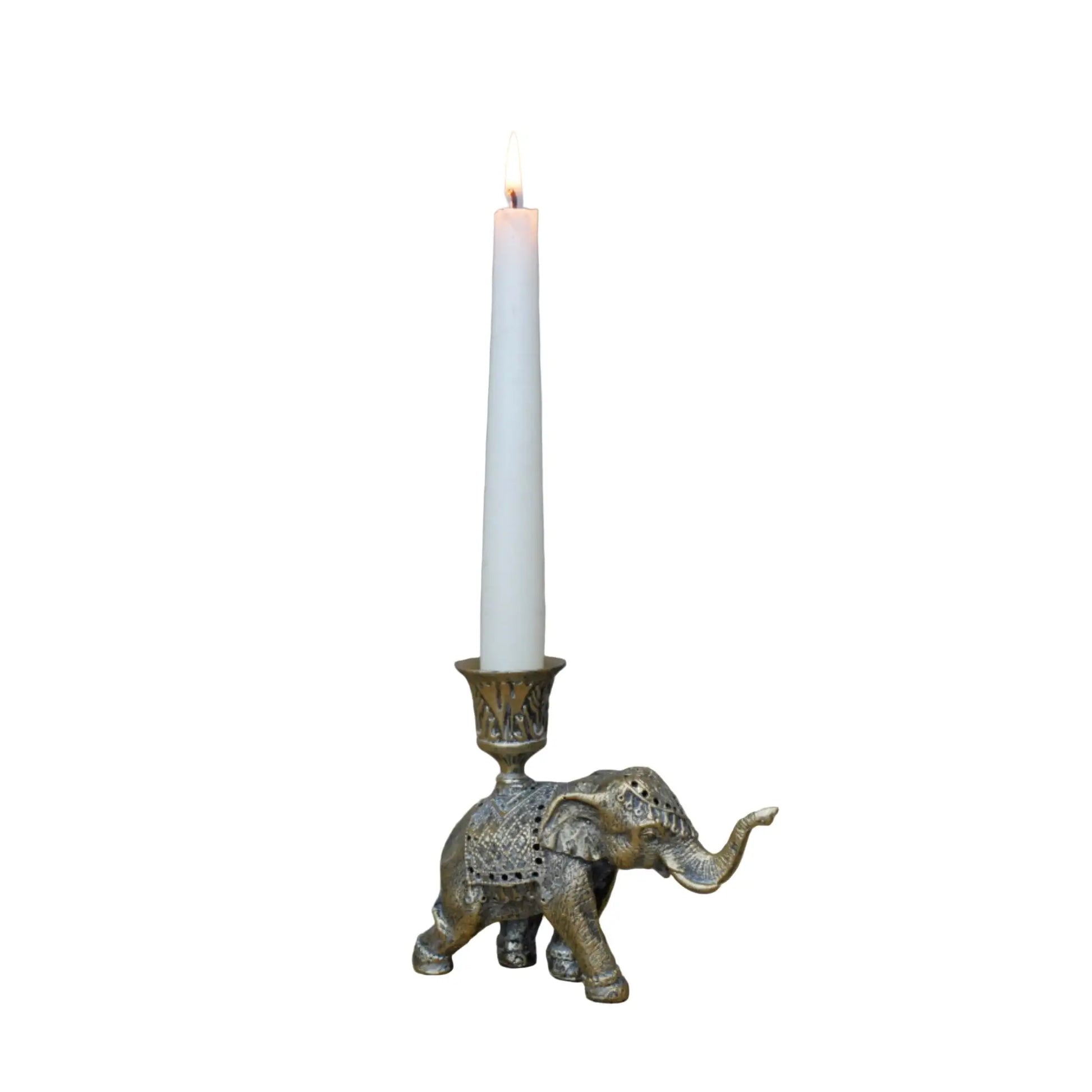 Decorative elephant candle holder with a lit candle on a wooden surface.