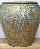 Decorative ceramic vase with textured surface on a wooden surface