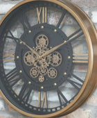 Decorative wall clock with gear design on a brick wall
