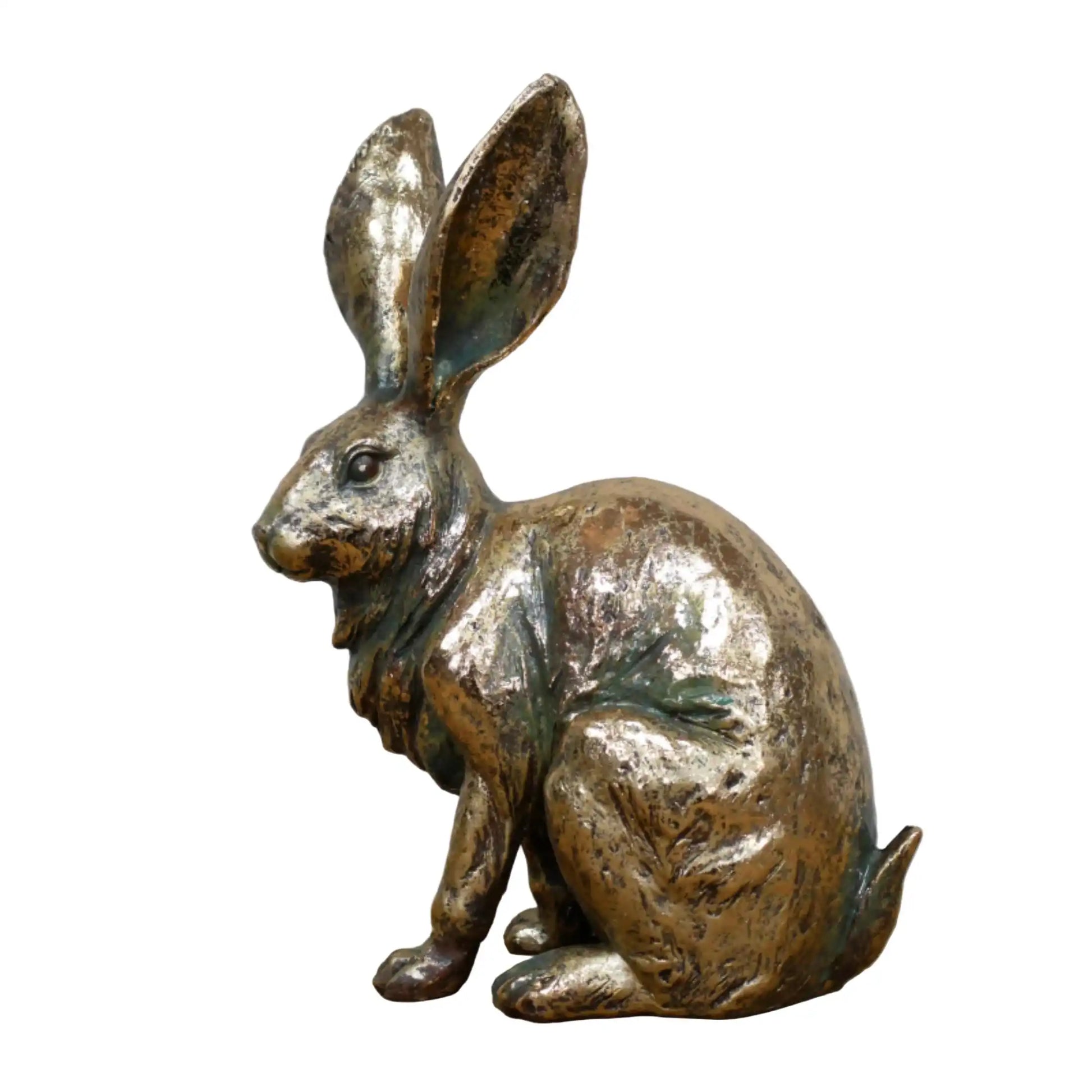 Bronze rabbit sculpture on a wooden surface with a gray background