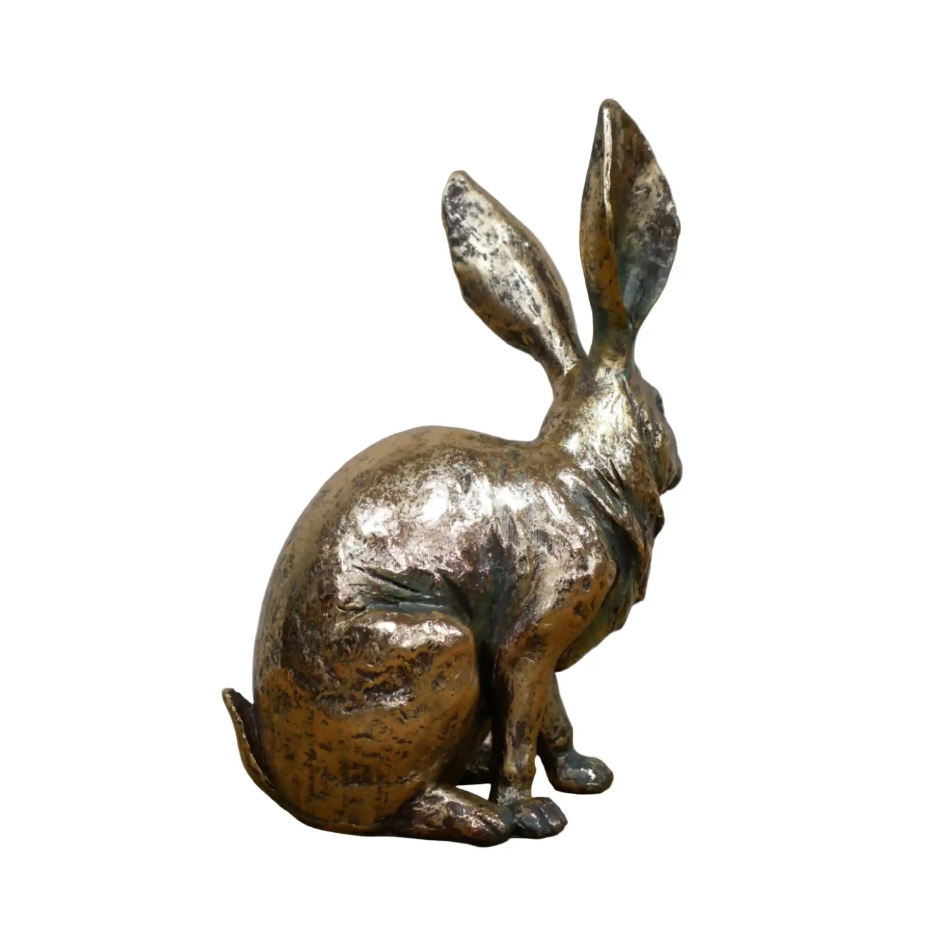 Bronze rabbit sculpture on a wooden surface with a gray background
