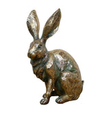 Bronze rabbit statue on a white background
