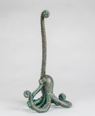 Bronze octopus sculpture on a white background