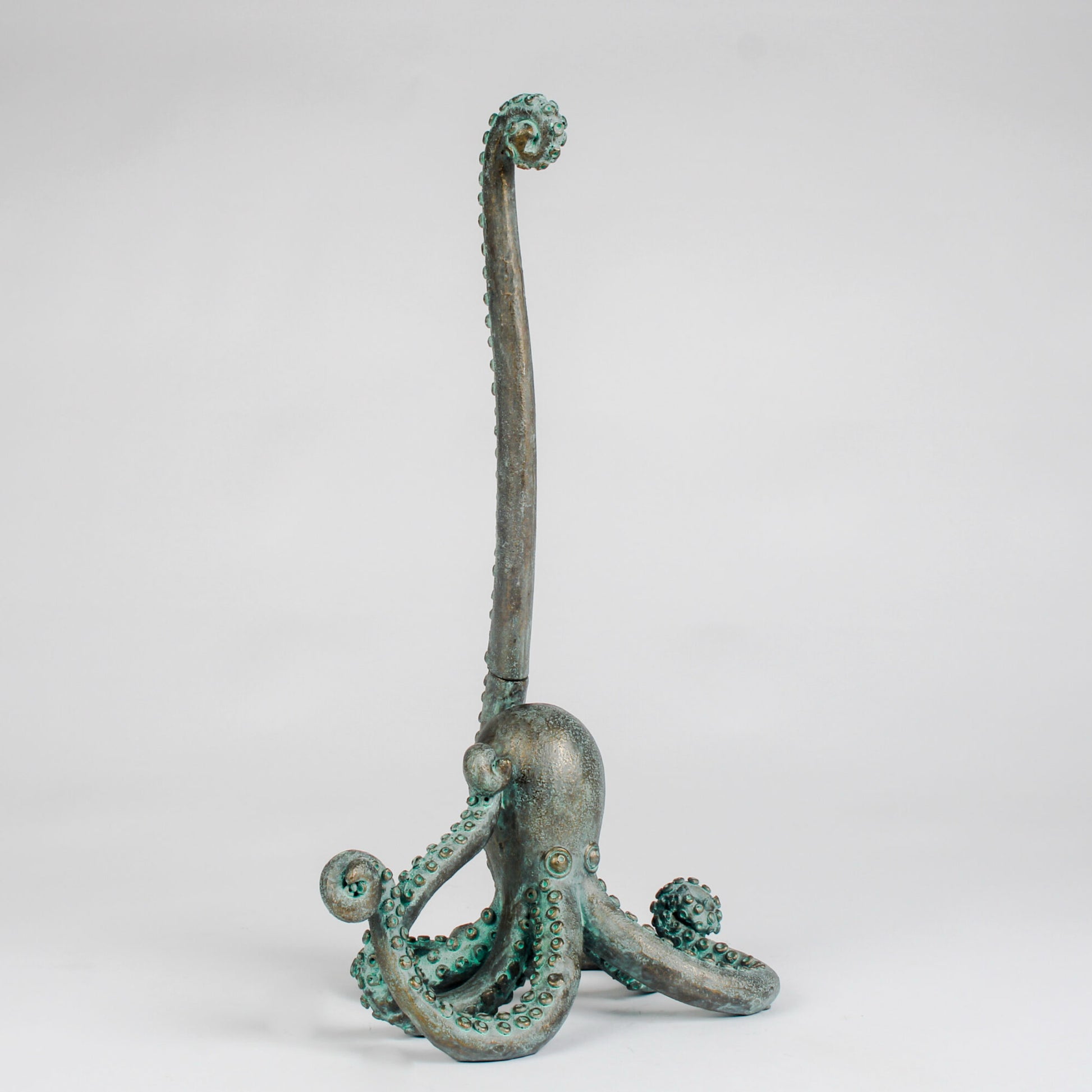 Bronze octopus sculpture on a white background