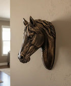 Bronze horse head sculpture on a wall