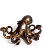 An octopus-shaped bronze candle holder with eight arms, each ending in a small cup, photographed on a clean white background.