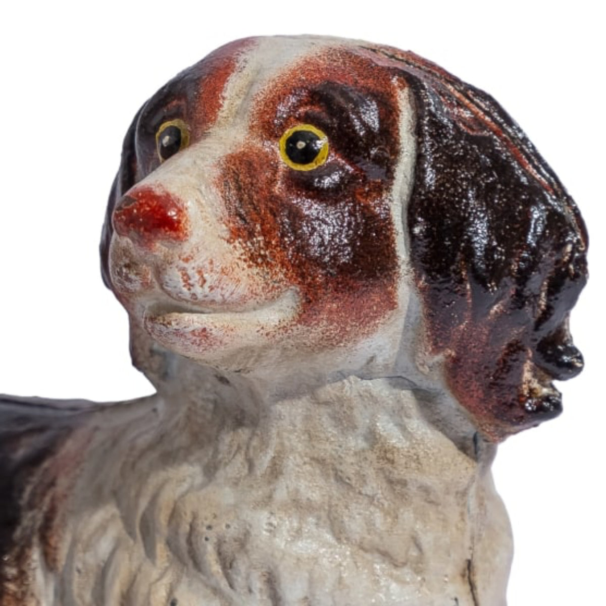 A ceramic dog figurine with a glossy brown and white glaze, featuring a white muzzle, dark brown ears, and yellow eyes, shown against a plain white background.
