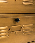Close-up of a gold metal locker with a black handle