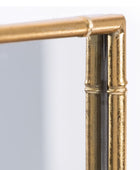 Gold-framed mirror corner on a white background
