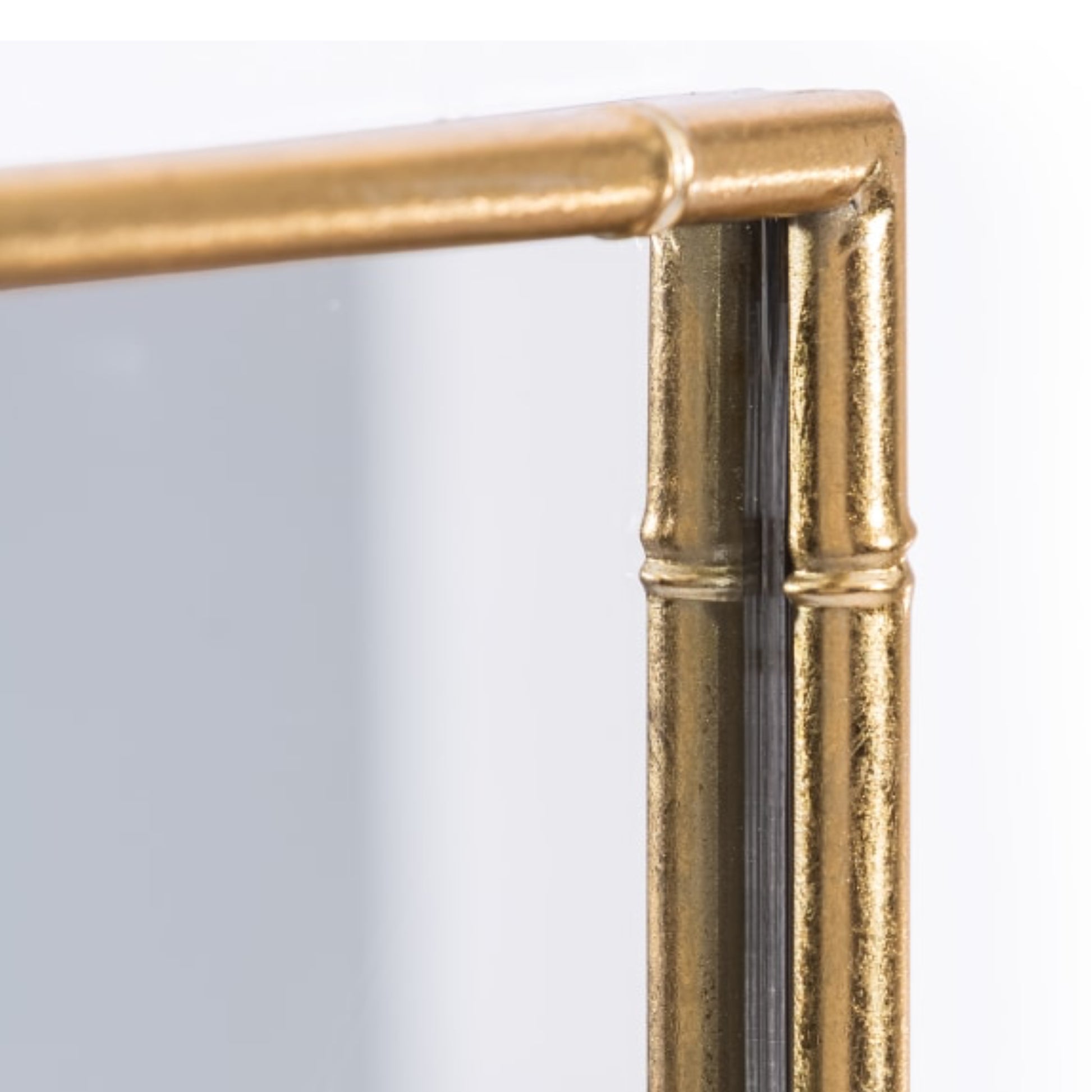 Gold-framed mirror corner on a white background