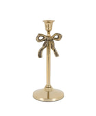 Gold candle holder with bow design on a white background