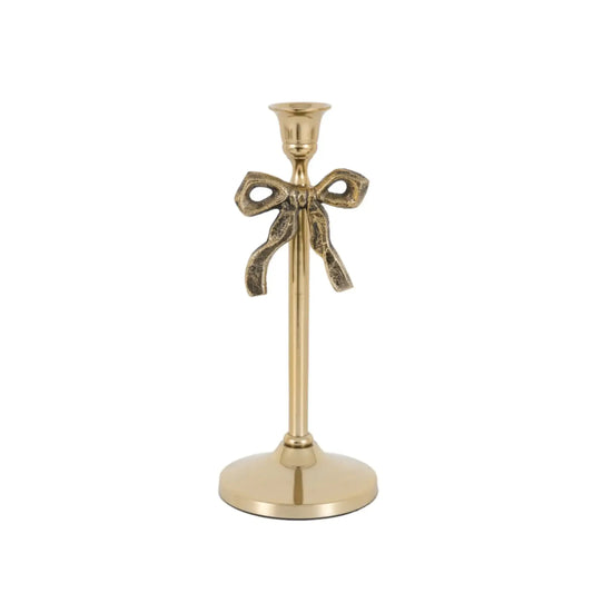 Gold candle holder with bow design on a white background