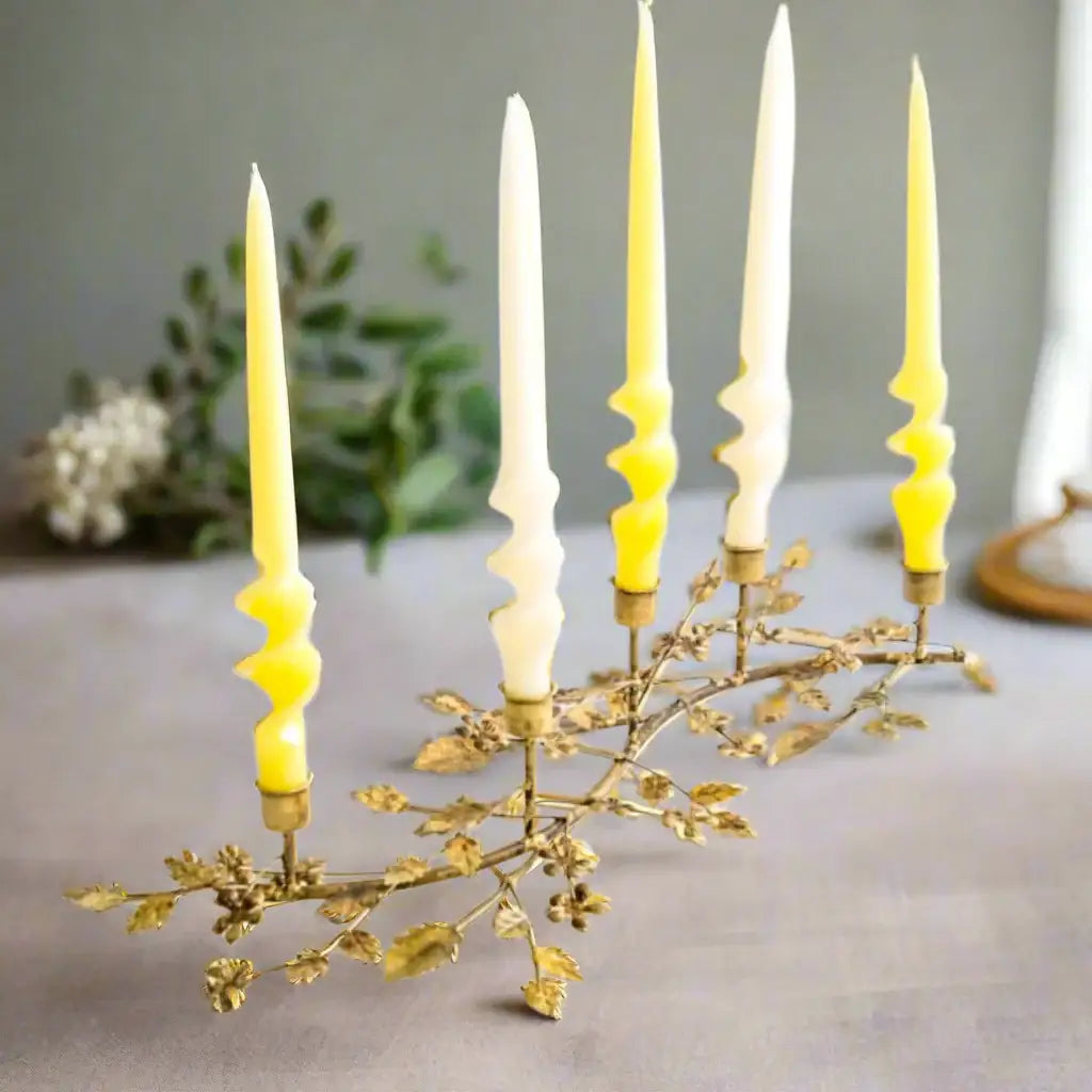 Decorative candle holder with yellow candles on a white background