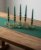 Decorative candle holder with yellow candles on a white background