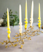Decorative candle holder with yellow candles on a white background
