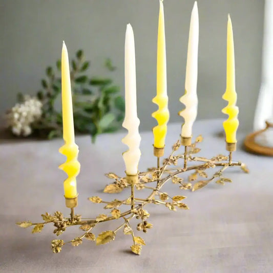 Decorative candle holder with yellow candles on a white background