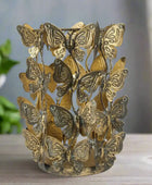 Decorative candle holder with butterfly designs on a white background