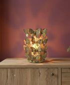Decorative butterfly lamp on a wooden cabinet with a warm glow against a blurred background
