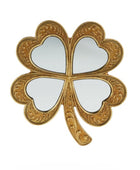 Decorative mirror shaped like a four-leaf clover with gold leaf design on a white background