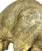 Bronze rhinoceros sculpture on a white background