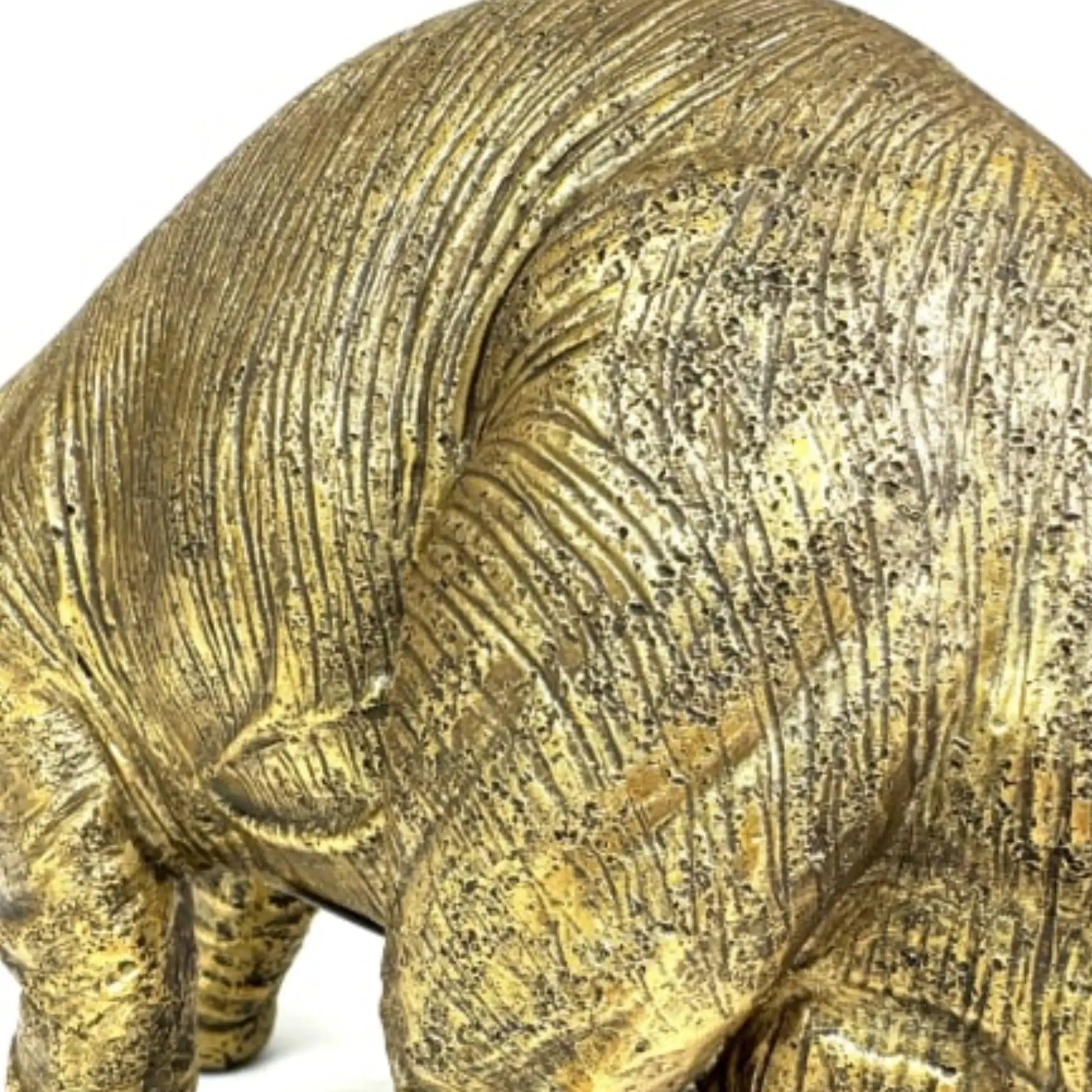 Bronze rhinoceros sculpture on a white background